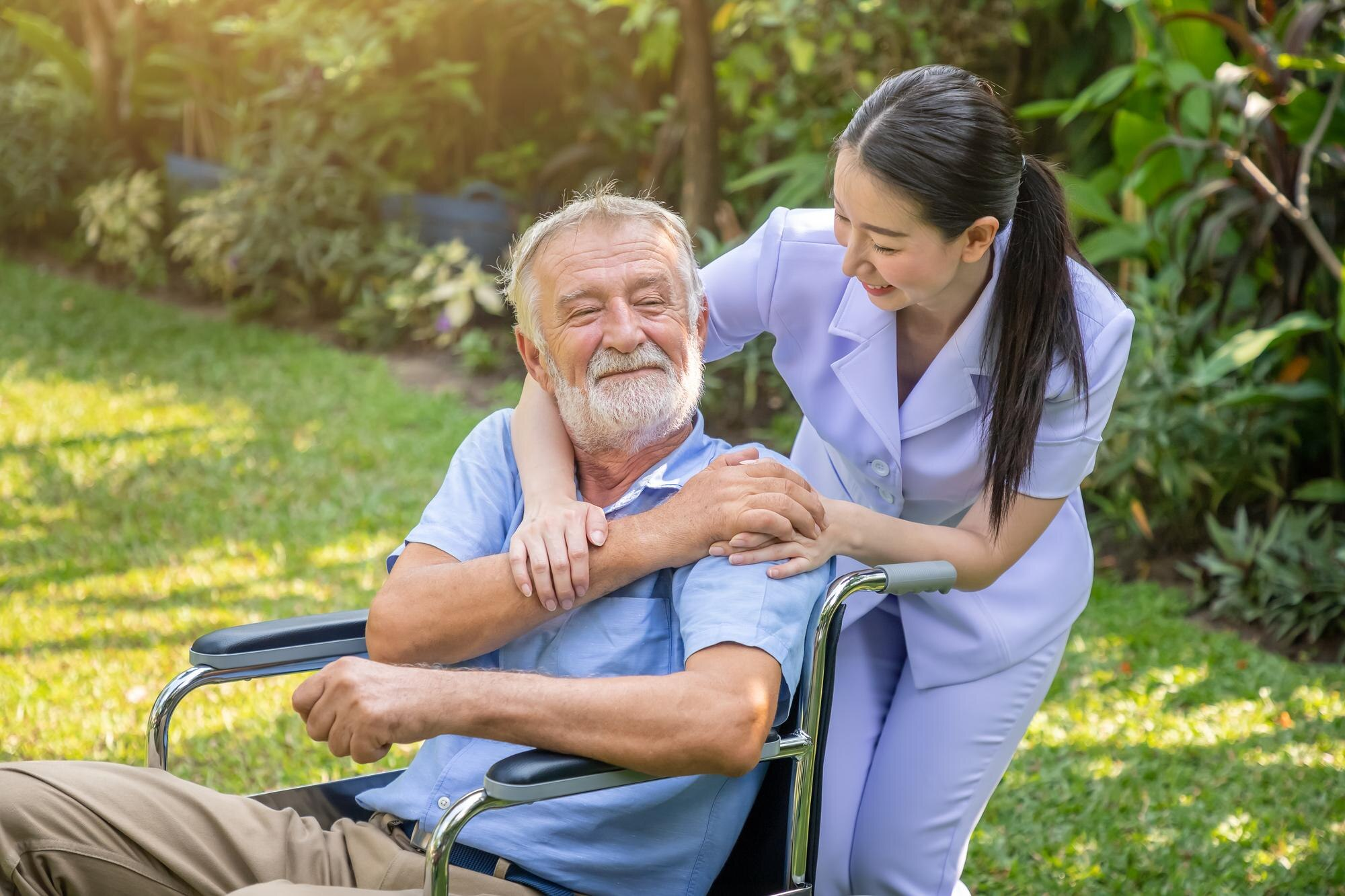 Caregiver with elderly man in wheelchair